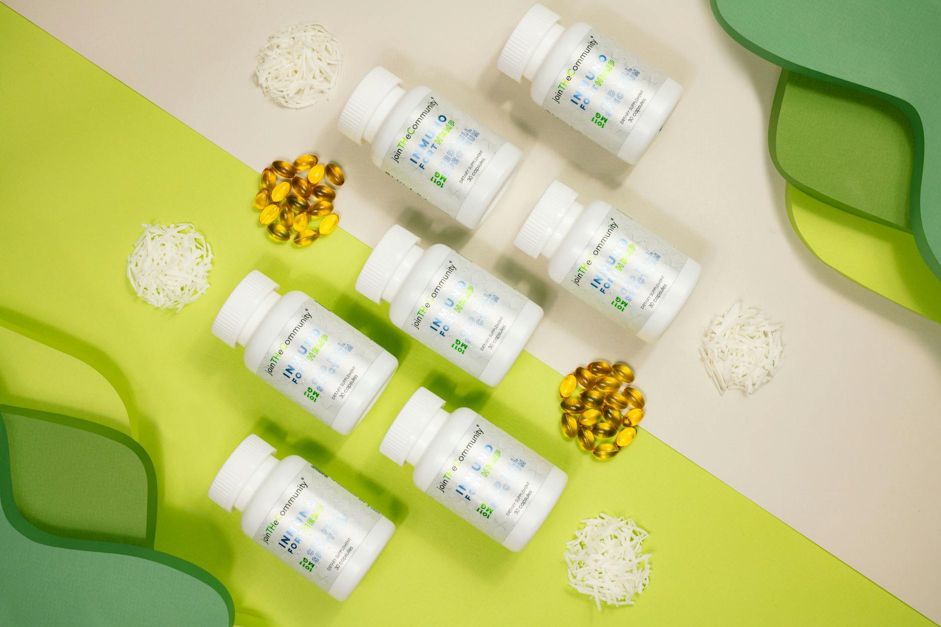 Flat lay of vitamin bottles with capsules and decorative elements against a green and white backd... (Photo by Saul Rivera on Pexels)
